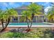 Large rectangular pool in backyard with palm trees at 1542 Mccrea Dr, Lutz, FL 33549