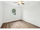 Well-lit bedroom featuring a window and ceiling fan at 15958 Adobe Dr, Hudson, FL 34667