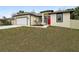 Brand new house with red front door and attached garage at 15958 Adobe Dr, Hudson, FL 34667