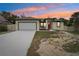 Newly built home with a red door and attached garage at 15958 Adobe Dr, Hudson, FL 34667