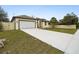 Newly built home with a white garage door and long concrete driveway at 15958 Adobe Dr, Hudson, FL 34667