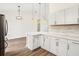 Modern kitchen with white cabinets, quartz countertops and breakfast bar at 15958 Adobe Dr, Hudson, FL 34667