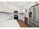 Modern kitchen with white cabinets, stainless steel appliances, and quartz countertops at 15958 Adobe Dr, Hudson, FL 34667