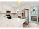 Modern kitchen with white cabinets, quartz countertops, and breakfast bar at 15958 Adobe Dr, Hudson, FL 34667