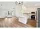 Modern kitchen with white cabinets, quartz countertops, and stainless steel appliances at 15958 Adobe Dr, Hudson, FL 34667