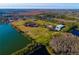 Aerial view of expansive equestrian property with large pasture and riding arena at 18029 Lake Reflections Blvd, Lutz, FL 33558