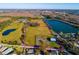 Aerial view showing property boundaries of a large lot with a barn near a lake at 18029 Lake Reflections Blvd, Lutz, FL 33558