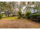 Spacious backyard with large oak trees and a partially visible home at 18029 Lake Reflections Blvd, Lutz, FL 33558