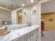 Bathroom with marble countertop and view into bedroom at 18029 Lake Reflections Blvd, Lutz, FL 33558