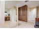 Bathroom with a large mirror, double doors, and tiled floors at 18029 Lake Reflections Blvd, Lutz, FL 33558