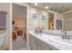 Bathroom with marble countertop and view into bedroom at 18029 Lake Reflections Blvd, Lutz, FL 33558