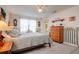 Charming bedroom with wood dresser and light-toned bedding at 18029 Lake Reflections Blvd, Lutz, FL 33558