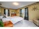 Bedroom with brass bed frame and yellow walls at 18029 Lake Reflections Blvd, Lutz, FL 33558