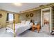 Bedroom with brass bed frame and plaid wallpaper at 18029 Lake Reflections Blvd, Lutz, FL 33558