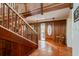 Inviting entryway with terracotta tile floors, wooden staircase, and stained-glass door at 18029 Lake Reflections Blvd, Lutz, FL 33558