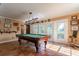 Game room with pool table and view of the backyard at 18029 Lake Reflections Blvd, Lutz, FL 33558