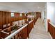 Long hallway with wooden railings overlooking the living area at 18029 Lake Reflections Blvd, Lutz, FL 33558