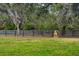 A horse stands in a lush green pasture with a wooden fence at 18029 Lake Reflections Blvd, Lutz, FL 33558