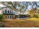 Back of house showing screened porch and stone accents at 18029 Lake Reflections Blvd, Lutz, FL 33558