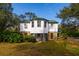 Exterior view of two-story house with stone and wood siding at 18029 Lake Reflections Blvd, Lutz, FL 33558