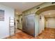 Modern kitchen with stainless steel refrigerator, custom cabinetry, and terracotta tile floors at 18029 Lake Reflections Blvd, Lutz, FL 33558