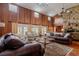 Spacious living room with vaulted ceilings, stone fireplace, and leather sofas at 18029 Lake Reflections Blvd, Lutz, FL 33558