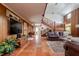 Open living room with high ceilings, exposed beams, and a grand staircase at 18029 Lake Reflections Blvd, Lutz, FL 33558