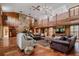 Large living area with stone fireplace and high, wood-beamed ceiling at 18029 Lake Reflections Blvd, Lutz, FL 33558