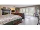 Main bedroom with hardwood floors, fireplace, and access to private balcony at 18029 Lake Reflections Blvd, Lutz, FL 33558