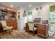 Home office with built-in wooden desk and cabinets at 18029 Lake Reflections Blvd, Lutz, FL 33558