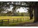 Serene pasture with wooden fencing and large oak tree at 18029 Lake Reflections Blvd, Lutz, FL 33558