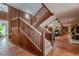 Grand wooden staircase with tiled floors, showcasing the home's unique architecture at 18029 Lake Reflections Blvd, Lutz, FL 33558