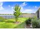 Backyard with lake view, landscaping and tree at 18058 Turning Leaf Cir, Land O Lakes, FL 34638