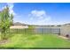 Landscaped backyard with lake view and fence at 18058 Turning Leaf Cir, Land O Lakes, FL 34638