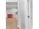 Interior view of a hallway looking towards a kitchen with white cabinets at 18058 Turning Leaf Cir, Land O Lakes, FL 34638