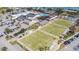 Aerial view of community center with pool, lawn bowling, and parking at 1809 Wolf Laurel Dr, Sun City Center, FL 33573