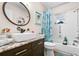 Bathroom with granite vanity, walk-in shower, and coastal decor at 1809 Wolf Laurel Dr, Sun City Center, FL 33573