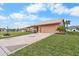 Single-story home with a two-car garage and landscaped yard at 1809 Wolf Laurel Dr, Sun City Center, FL 33573