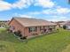 Single-story home with a terracotta roof and landscaped yard at 1809 Wolf Laurel Dr, Sun City Center, FL 33573