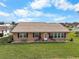 Single story home with terracotta roof and manicured lawn at 1809 Wolf Laurel Dr, Sun City Center, FL 33573