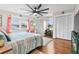 Relaxing main bedroom with large windows, a ceiling fan, and built-in closets at 1809 Wolf Laurel Dr, Sun City Center, FL 33573