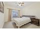 Bedroom with queen bed, large window, and ceiling fan at 18402 Bridle Club Dr # 18402, Tampa, FL 33647