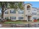 Condo building exterior featuring light-yellow siding, dark-green trim, and a well-maintained entrance at 18402 Bridle Club Dr # 18402, Tampa, FL 33647