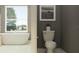 Modern bathroom with a free-standing tub and updated fixtures at 18412 Serene Lake Loop, Lutz, FL 33548