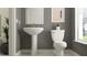 Convenient powder room with pedestal sink and toilet at 18412 Serene Lake Loop, Lutz, FL 33548