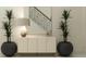 Bright entryway with console table, mirror, and two potted plants at 18412 Serene Lake Loop, Lutz, FL 33548