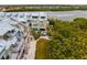 Aerial view of townhouses near the water with metal roofs and balconies at 19915 Gulf Blvd # 303, Indian Shores, FL 33785