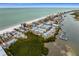 Aerial view of a beachside community, showcasing homes and water access at 19915 Gulf Blvd # 303, Indian Shores, FL 33785