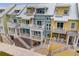 Aerial view of townhouses with multiple levels, balconies, and staircases at 19915 Gulf Blvd # 303, Indian Shores, FL 33785