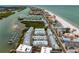 Aerial view of waterfront community, showcasing beach, homes, and boats at 19915 Gulf Blvd # 303, Indian Shores, FL 33785